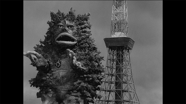 A screen capture from the 4K restoration of the "Garamon Strikes Back" episode of the 1966 Ultra Q tokusatsu TV series, featuring the titular monster attacking Tokyo Tower.