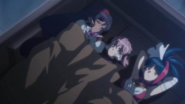 Elza, Millaarc and Vanessa lying together in the back of a van, with the seats down as a make-shift bed.