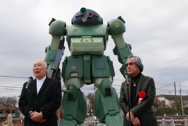 Armored Trooper VOTOMS director Ryosuke Takahashi and mechanical designer Kunio Okawara are on-hand for the unveiling of the life-size Scopedog statue in Inagi Pear Park in Inagi, Tokyo, Japan.