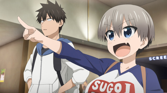 Hana Uzaki, the boisterous heroine of the upcoming Uzaki-chan Wants to Hang Out! TV anime, points enthusiastically at something off-camera while her friend, Shinichi Sakurai, looks on with a bemused expression.