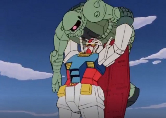 The RX-78-2 Gundam prepares to body-slam a Zaku mobile suit in a scene from the original Mobile Suit Gundam TV anime.
