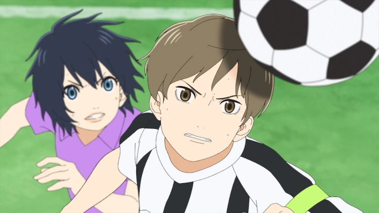 Nozomi Onda and Yasuaki Tani chase the same soccer ball in a heated match in a scene from the upcoming Farewell, My Dear Cramer --First Touch anime theatrical film.